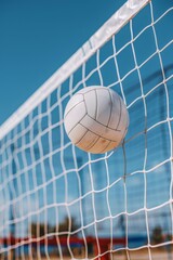 Beach volleyball  ball and net under clear blue sky   summer seaside recreation and beach sports