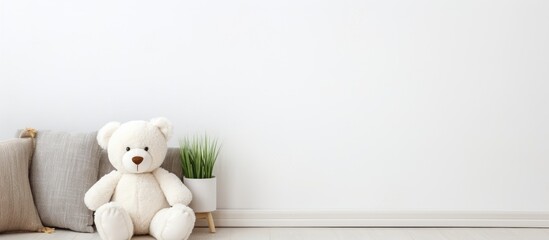 Teddy bear on couch near plant