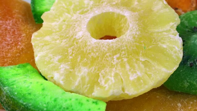 Different dried candied fruit with sugar circle rotation close up