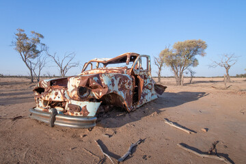 Fototapeta premium rusty car wreck, rusted abandoned derelict junk metal, outback Queensland Australia