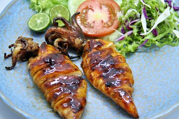 Grilled squids or 'Cumi Bakar' is a sweet and tangy seafood dish that is often sold as street food...