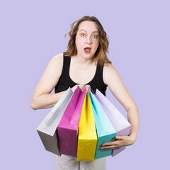 Cheerful woman with packages rejoices at successful purchases at sale. High quality photo