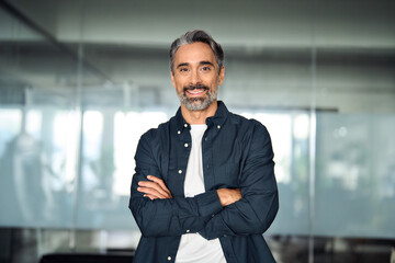 Smiling middle aged ceo business man looking at camera, portrait. Confident happy mature older professional businessman executive manager, male investor in shirt standing arms crossed in office. - obrazy, fototapety, plakaty