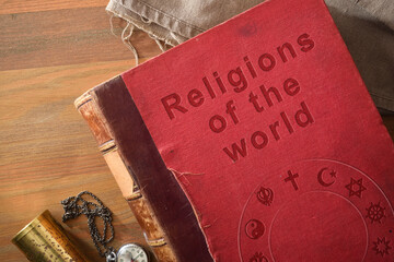 Detail of book of world religions on wooden table