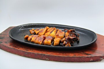 Grilled squids or 'Cumi Bakar' is a sweet and tangy seafood dish that is often sold as street food...