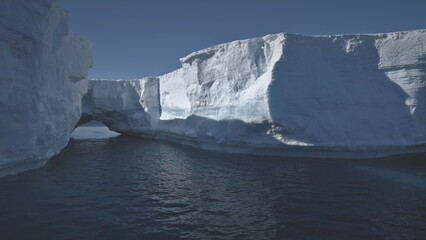 Iceberg Arch Antarctic Ocean Glacier Seascape. Hole in Massive Ice Berg Floating in Arctic Blue...