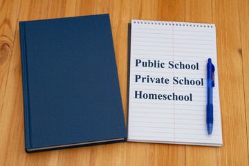  Public vs private vs homeschool schools with retro old blue book with notepad and pen