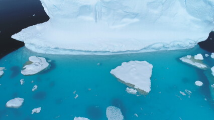 Antarctica iceberg float ocean glacier aerial view. Polar winter peninsula open water coast melting...