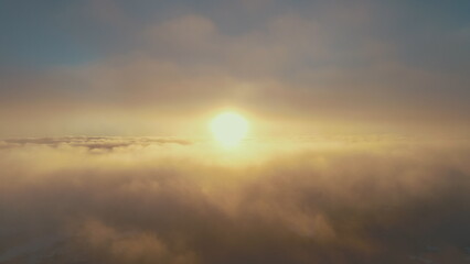 Sun in fog white clouds sky. Sunset aerial drone flight view. Bright yellow, orange epic panoramic overview above the fast moving surface fog covering Antarctica. Overwhelmed scape. Amazing .