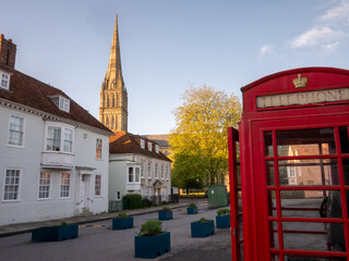 Fototapeta na wymiar Telephone box and spire in a historic town 