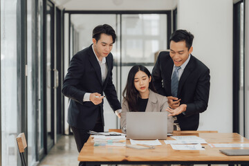 Young multiethnic diverse creative asian group huddle and high five hands together in office workshop with success or empower expression in teamwork. Young asian marketing team with copy space