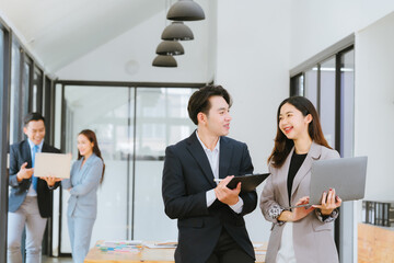 Young multiethnic diverse creative asian group huddle and high five hands together in office...