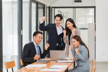 Young motivated Asian business team discussing oh business strategy in the modern meeting room.