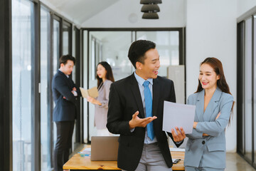 Meeting of Asian business people who are committed to work. Creative business teams work together in the office, discussing issues that need to be resolved, and