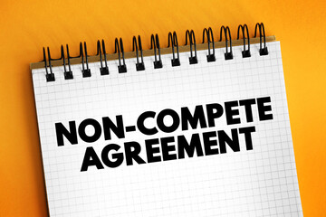 Non-compete Agreement - contract where an employee agrees not to compete with an employer after the employment period is over, text concept on notepad - 796425218
