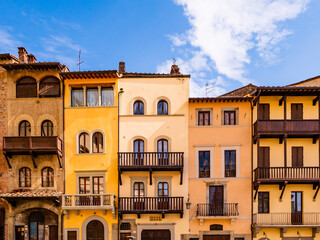 Picturesque row of medieval buildings in Arezzo old town square, Tuscany, Italy
