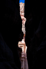 A glimpse of The Treasury from the canyon in the archeological site of Petra in Jordan