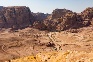 A view from above of the valley of the archeological site of Petra in Jordan with a view of Qasr al-Bint