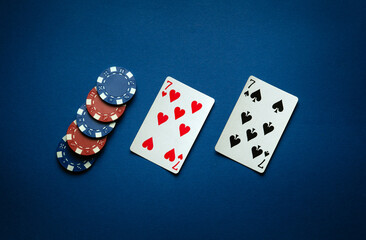 Luck in a poker game with a winning one pair combination. Playing cards and chips are laid out in a...
