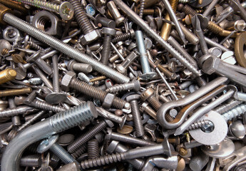 A pile of iron fasteners such as screws, bolts, nails, couplings and other hardware materials