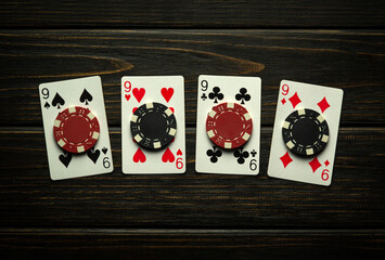 A gambling game of poker with a lucky winning combination of four of a kind or quads. Playing cards...