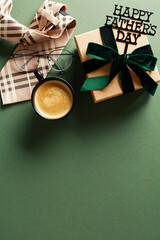 Happy Fathers Day flat lay composition with gift box, tie, coffee cup on green background.