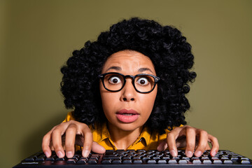 Photo of nice young woman typing keyboard wear yellow shirt isolated on khaki color background