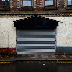 The entrance to a market building covered with a steel shutter