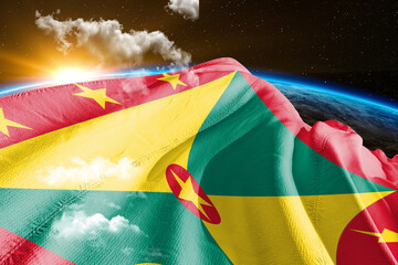 Grenada national flag cloth fabric waving on beautiful night global cloud Background.