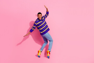 Full length photo of good mood cheerful guy dressed striped pullover enjoying disco empty space...