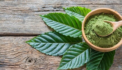 top view of mitragyna speciosa kratom leaves with powder in the wooden cup on wooden background