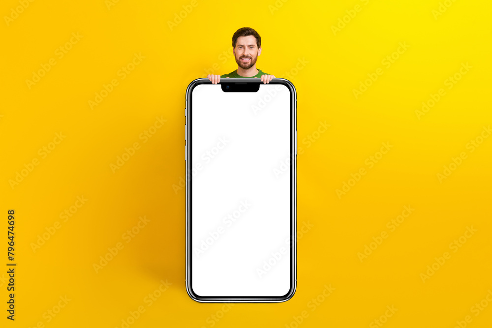 Poster Full body length photo cadre of cheerful handsome man holding huge phone display menu web message isolated on yellow color background