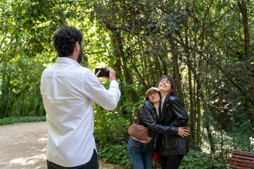 three friends taking pictures with their cell phones