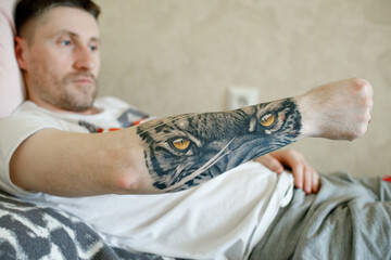 Vinnytsia, Ukraine. April 15, 2024: A guy got a tiger tattoo on his arm. The look of the beast. Art. Self-expression
