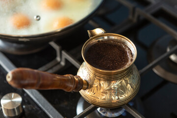 Close up shot of preparation of turkish coffee using copper cezve on the gas stove	