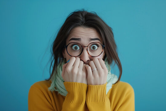 Nervous woman in studio with oops reaction on blue background. Mistake, sorry and female overwhelmed by fake news, drama or secret with regret.