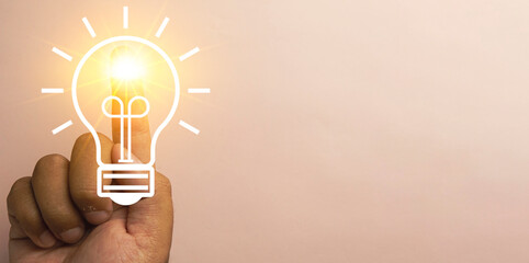  Image of Creative Inspiration and Innovative Ideas.,Hand Pointing with Glowing Light Bulb Icon on Finger Symbolizing Innovation and Genius Ideas. - Powered by Adobe