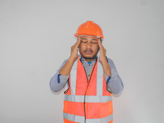 Adult Asian man grabbing his head showing desperate