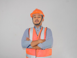 Asian constructor worker man with safety vest stand croosed his arm with confidence gesture