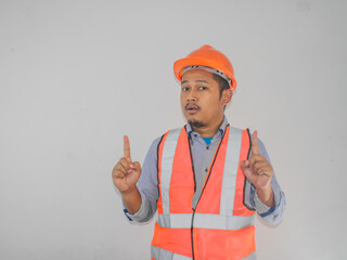 A man wearing construction socked expression with thumbs up pointing