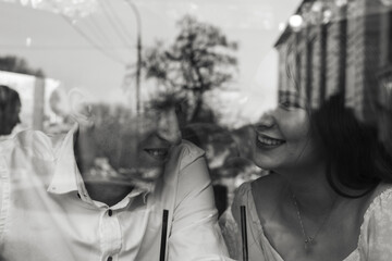 Loving couple on a date at coffee shop. Black and white image. Selective focus.
