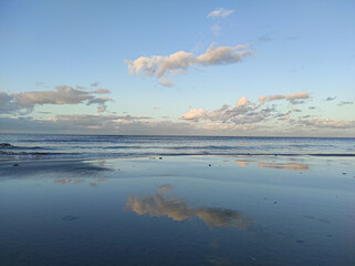 clouds over the sea with reflection in water