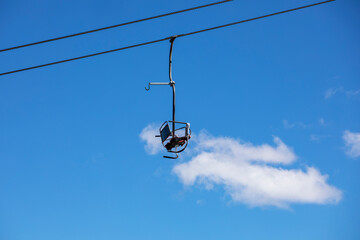 observation chair on a flat lift high in the sky. leisure.ski boots close up on the slope
