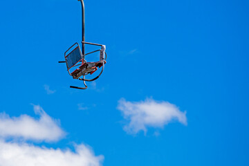 observation chair on a flat lift high in the sky. leisure.ski boots close up on the slope