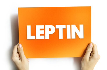 Leptin is a hormone made by adipose cells and its primary role is to regulate long-term energy balance, text concept on card