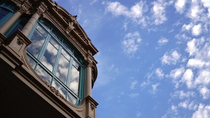 reflection of clouds in a building window