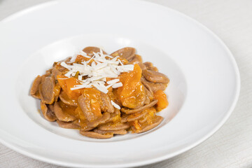 Strascinate with burnt wheat, a typical Apulian dish. Strascinate di grano arso, yellow cherry tomatoes and cacioricotta.
