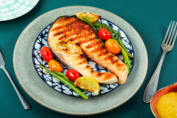 Plate of grilled salmon steak.