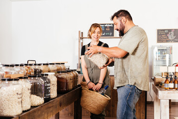 Couple Selecting Beans From Bulk Bins at Eco-Friendly Grocery Store