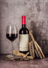 Drink photography of red wine, red; wine; wineglass; bottle; vintage, retro, aged, stone, wood, concrete, winery; drink; background; celebration; romance; bar, advertising